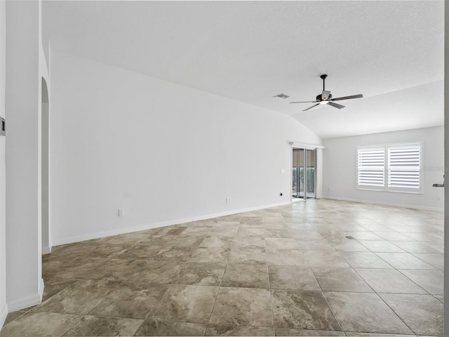 empty room featuring ceiling fan and lofted ceiling