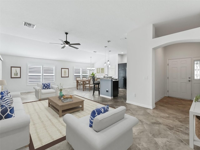 living room featuring ceiling fan and vaulted ceiling