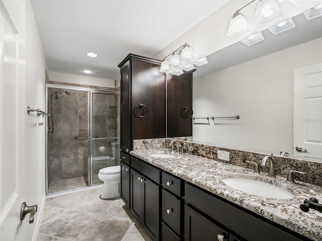 bathroom featuring vanity, toilet, and walk in shower