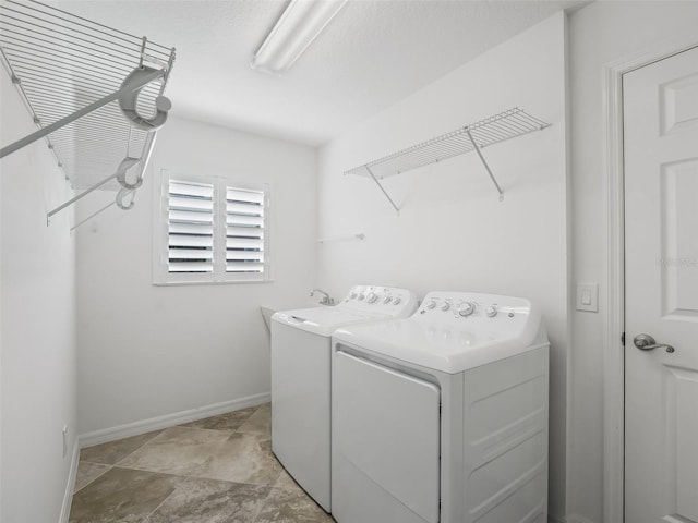 clothes washing area with washing machine and clothes dryer