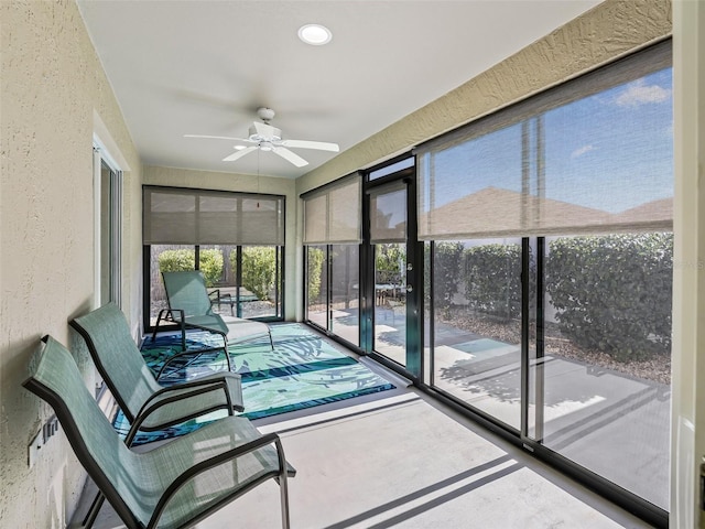 sunroom / solarium featuring ceiling fan