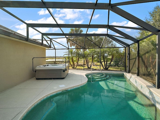 view of swimming pool featuring glass enclosure and a patio