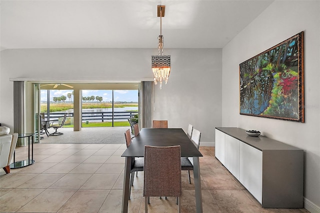 dining area with light tile patterned flooring and a chandelier