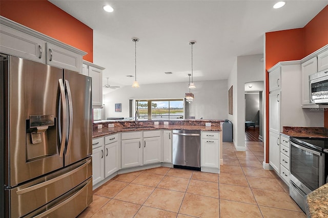 kitchen featuring white cabinets, sink, hanging light fixtures, appliances with stainless steel finishes, and kitchen peninsula