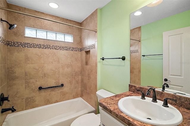 full bathroom featuring toilet, vanity, and tiled shower / bath