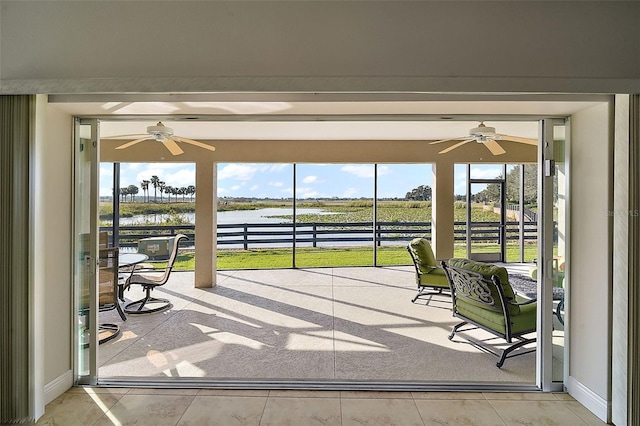 unfurnished sunroom featuring a water view