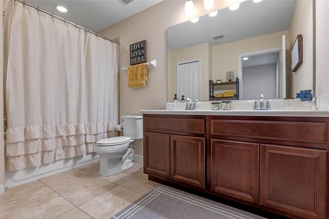 full bathroom with tile patterned floors, vanity, a textured ceiling, shower / bathtub combination with curtain, and toilet