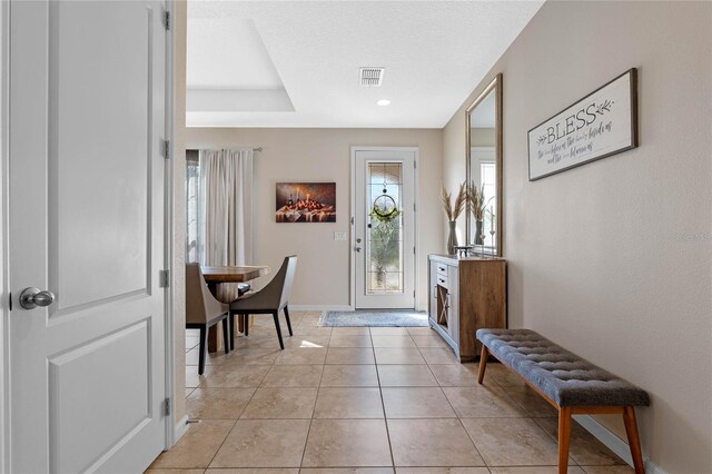 foyer featuring light tile patterned floors