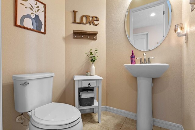 bathroom featuring toilet and tile patterned floors