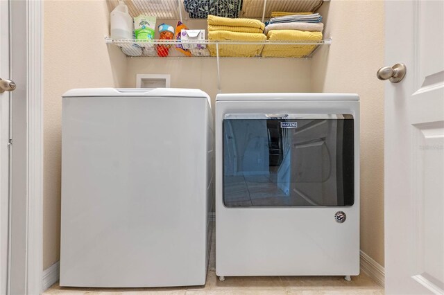 clothes washing area with washing machine and dryer