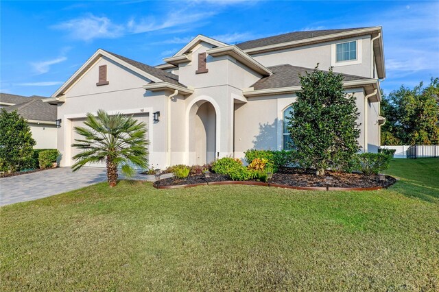 view of front of home featuring a garage and a front lawn