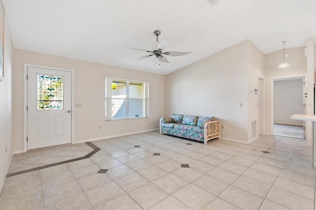 foyer with ceiling fan, lofted ceiling, and light tile patterned flooring