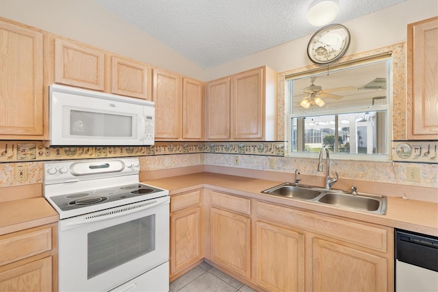 kitchen with light tile patterned flooring, white appliances, sink, and light brown cabinets