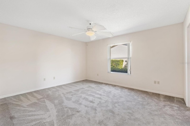 carpeted empty room with a textured ceiling and ceiling fan