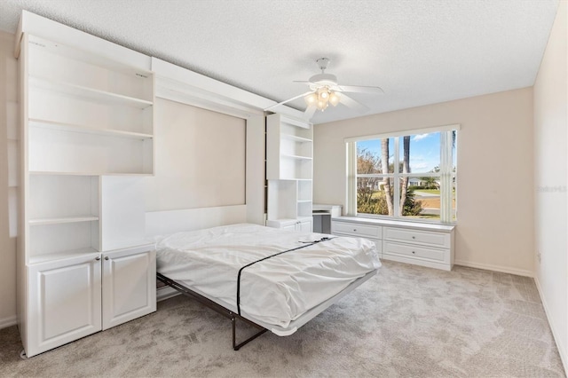 1201 De La Fuente Ct, The Villages, FL 32162 - bedroom featuring light carpet, a textured ceiling, baseboards, and ceiling fan