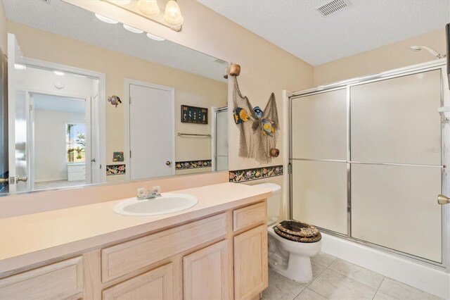 1201 De La Fuente Ct, The Villages, FL 32162 - bathroom featuring toilet, a stall shower, vanity, and tile patterned flooring