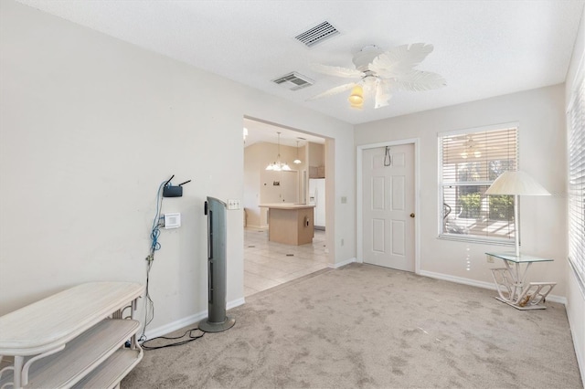 interior space with ceiling fan with notable chandelier