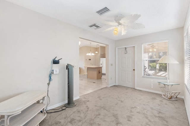 1201 De La Fuente Ct, The Villages, FL 32162 - foyer entrance with light colored carpet, a ceiling fan, baseboards, and a chandelier