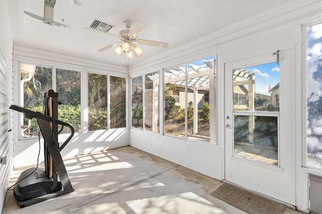 unfurnished sunroom with ceiling fan