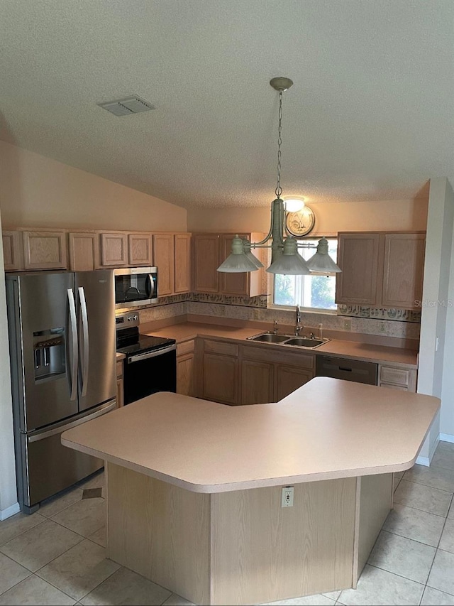 1201 De La Fuente Ct, The Villages, FL 32162 - kitchen featuring appliances with stainless steel finishes, a sink, light brown cabinetry, light tile patterned flooring, and a textured ceiling