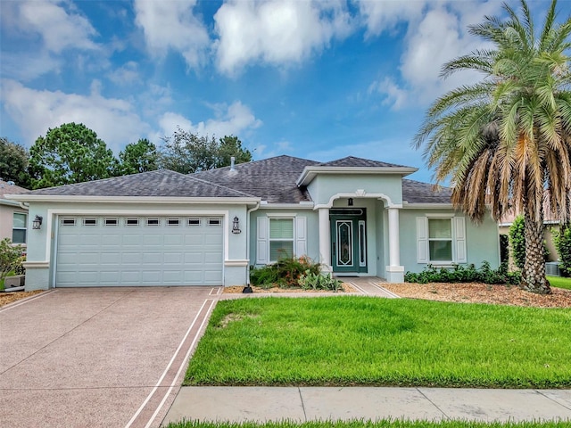 view of front of home featuring a front yard and a garage