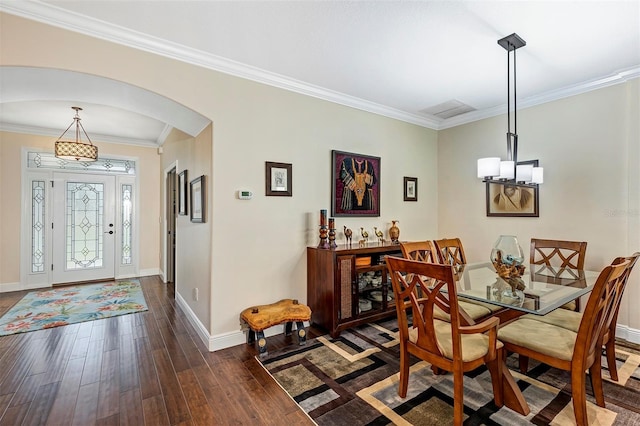 dining area featuring crown molding and dark hardwood / wood-style flooring