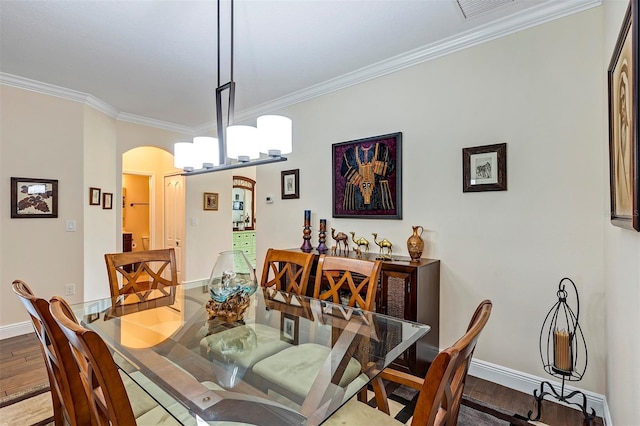 dining area featuring hardwood / wood-style floors and crown molding