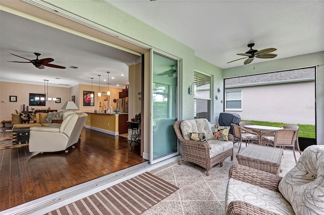 sunroom featuring ceiling fan