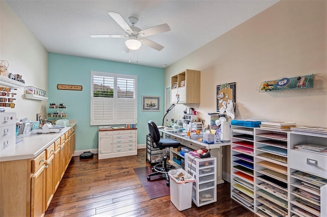 office area featuring dark hardwood / wood-style floors, ceiling fan, and a textured ceiling