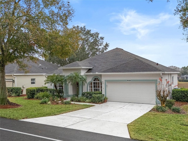 ranch-style home featuring a garage and a front lawn