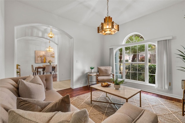 living room featuring light hardwood / wood-style flooring and a notable chandelier