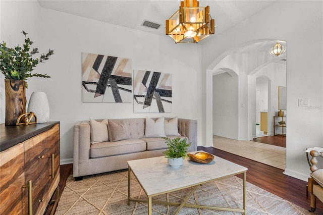 living room featuring an inviting chandelier and hardwood / wood-style floors