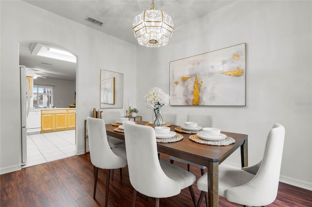 dining area featuring an inviting chandelier and wood-type flooring