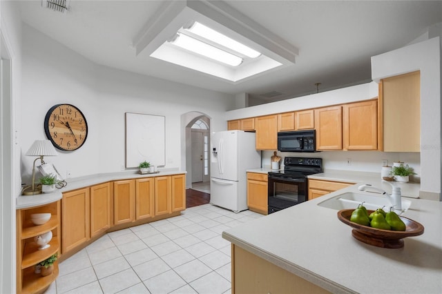 kitchen with light brown cabinetry, sink, light tile patterned floors, and black appliances