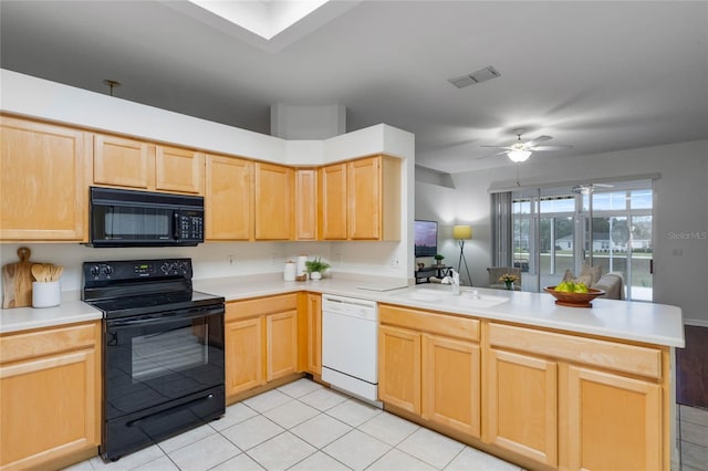 kitchen with sink, black appliances, light tile patterned flooring, light brown cabinetry, and kitchen peninsula