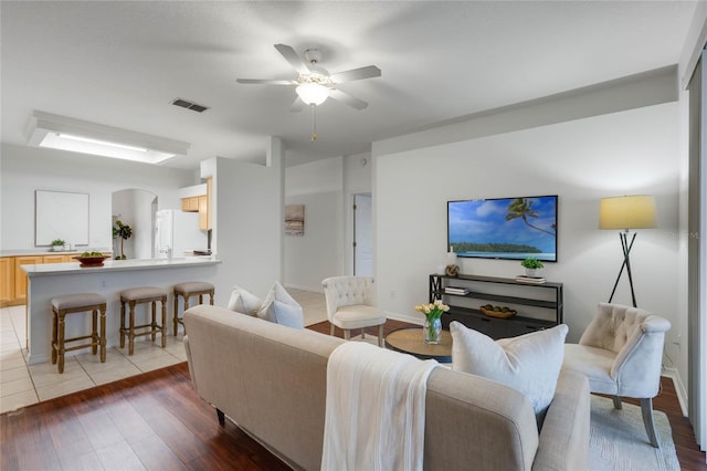 living room featuring ceiling fan and hardwood / wood-style floors