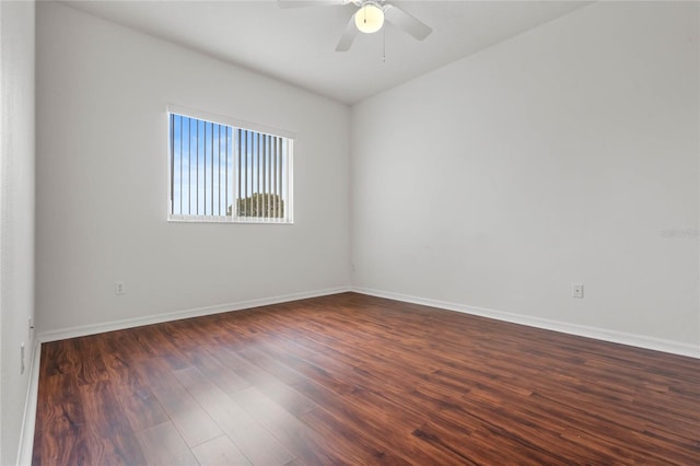 spare room with dark hardwood / wood-style floors and ceiling fan