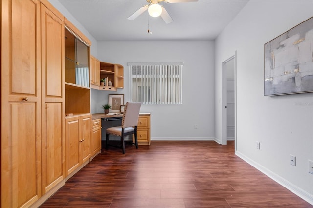 unfurnished office featuring dark wood-type flooring and ceiling fan