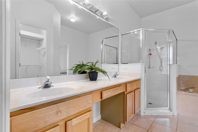 bathroom with vanity, a shower with shower door, and tile patterned floors