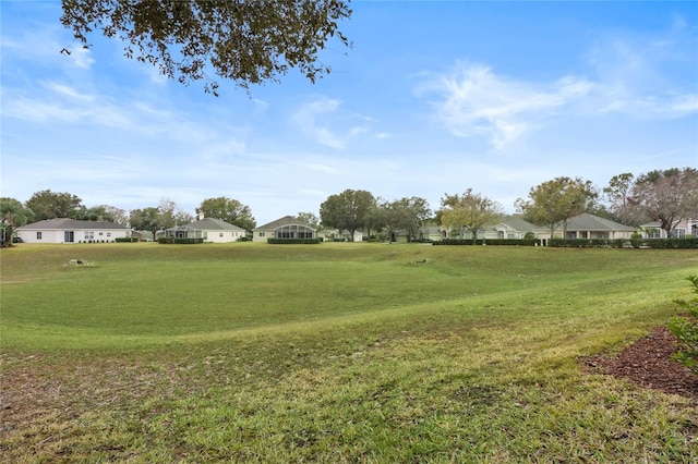 view of property's community featuring a yard