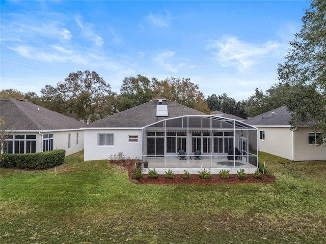 rear view of property with a lanai and a lawn