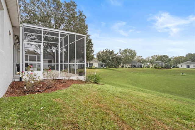 view of yard with glass enclosure