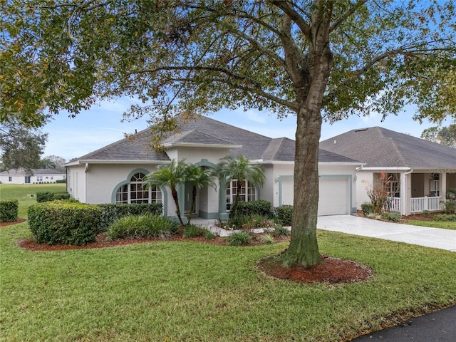 ranch-style home featuring a garage and a front yard