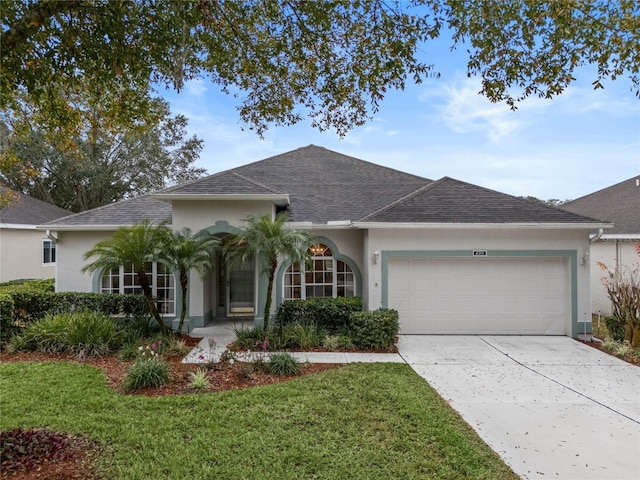 single story home with a garage and a front yard