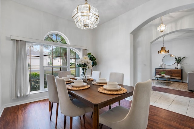 dining room with hardwood / wood-style flooring and an inviting chandelier