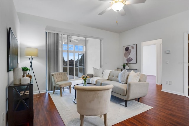 living room featuring dark wood-type flooring and ceiling fan