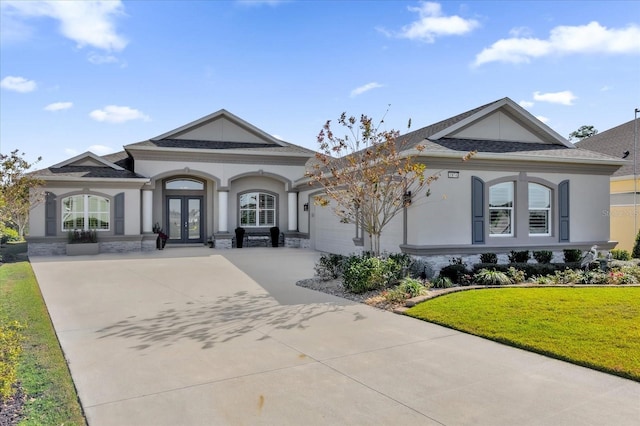 view of front of house with french doors and a front lawn