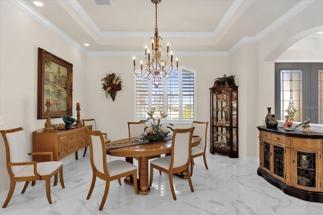 dining space with a chandelier, french doors, a tray ceiling, and ornamental molding