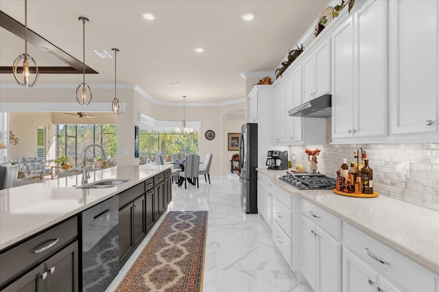 kitchen with sink, ornamental molding, appliances with stainless steel finishes, decorative light fixtures, and white cabinetry