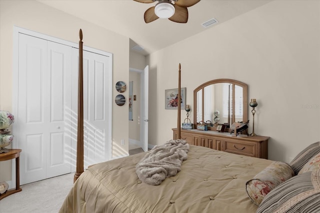 bedroom featuring ceiling fan, light carpet, and a closet